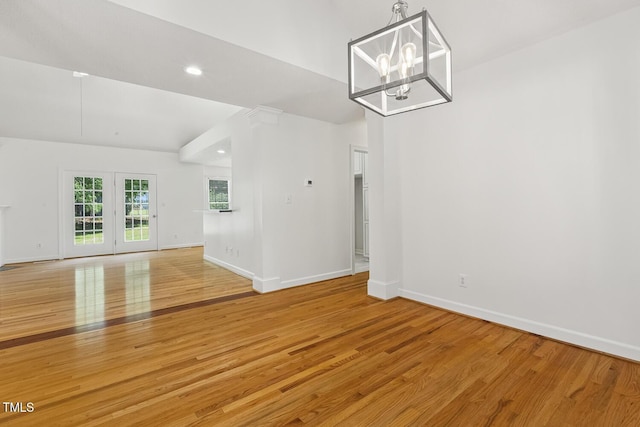 interior space with recessed lighting, baseboards, a notable chandelier, and light wood finished floors
