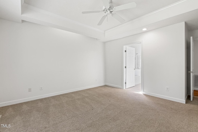 carpeted spare room featuring crown molding, baseboards, ceiling fan, recessed lighting, and a tray ceiling