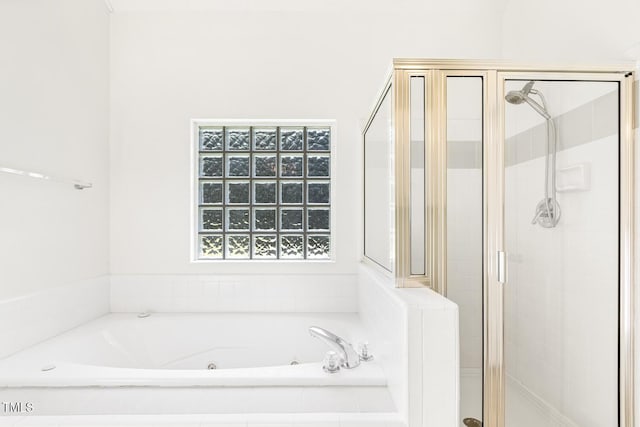full bathroom with a shower stall and a tub with jets