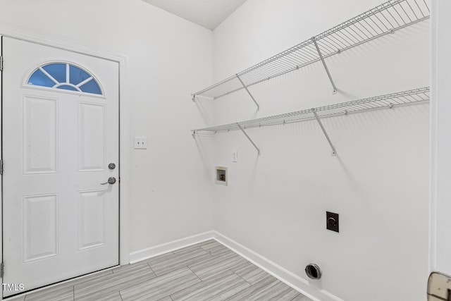 laundry area featuring hookup for an electric dryer, laundry area, baseboards, light wood finished floors, and hookup for a washing machine