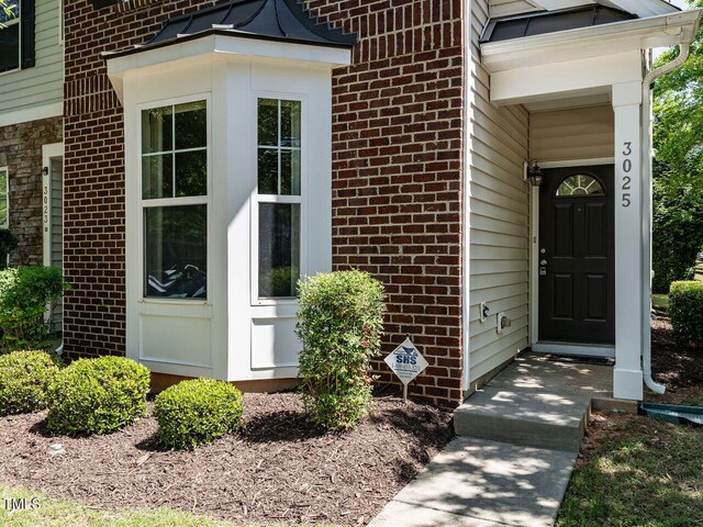 property entrance with brick siding