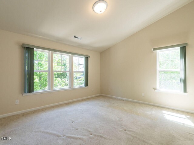 carpeted empty room with baseboards