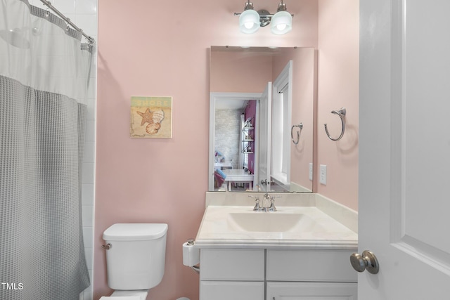 bathroom featuring toilet and vanity