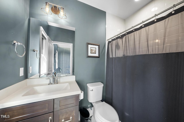 bathroom with toilet, curtained shower, and vanity