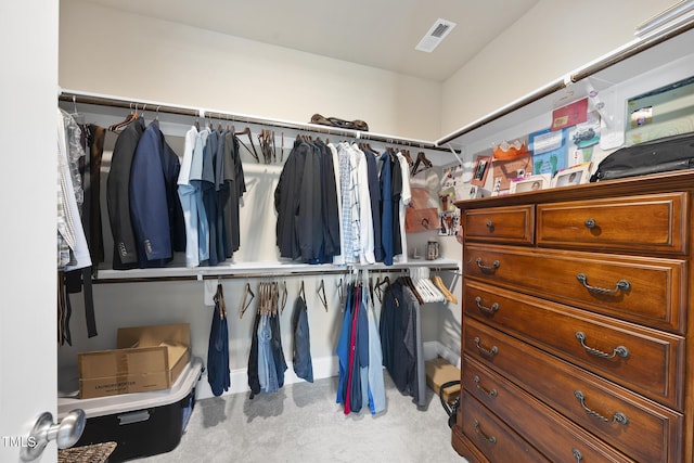 walk in closet featuring visible vents and carpet flooring