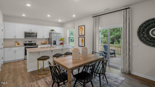 dining area with baseboards, recessed lighting, and wood finished floors