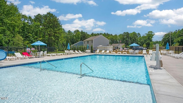 pool featuring fence and a patio area
