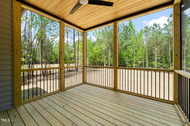 unfurnished sunroom featuring a ceiling fan