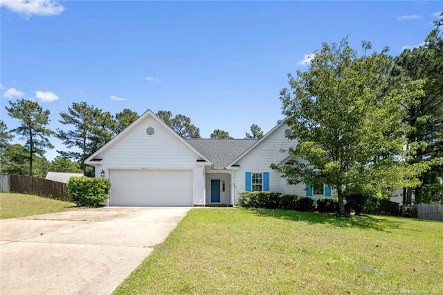 2495 Ohara Dr, Raeford, NC 28376 - ranch-style house with fence, an attached garage, concrete driveway, and a front lawn
