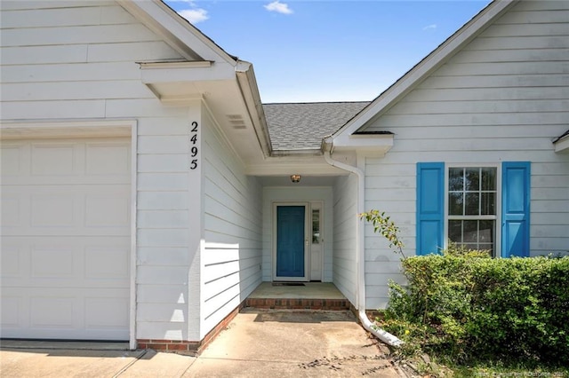 2495 Ohara Dr, Raeford, NC 28376 - view of exterior entry with a shingled roof and an attached garage