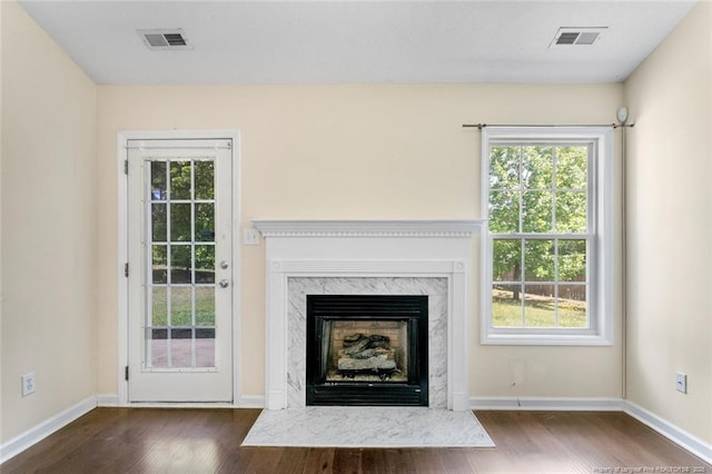 2495 Ohara Dr, Raeford, NC 28376 - unfurnished living room with baseboards, visible vents, wood finished floors, and a fireplace