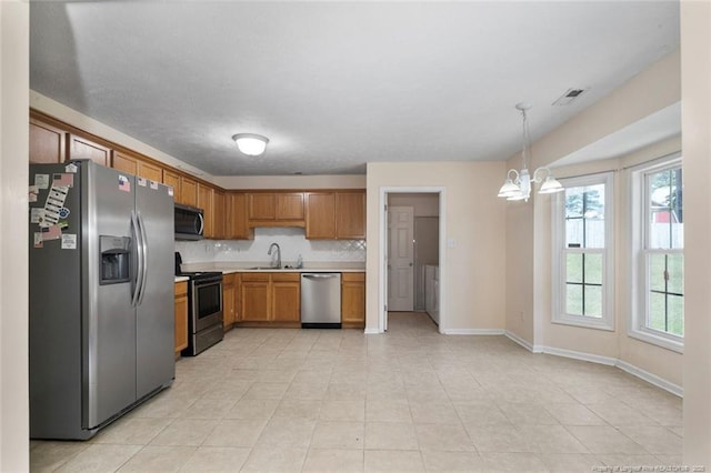 2495 Ohara Dr, Raeford, NC 28376 - kitchen with visible vents, light countertops, a chandelier, a sink, and appliances with stainless steel finishes