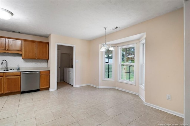 2495 Ohara Dr, Raeford, NC 28376 - kitchen with decorative backsplash, brown cabinets, dishwasher, light countertops, and baseboards