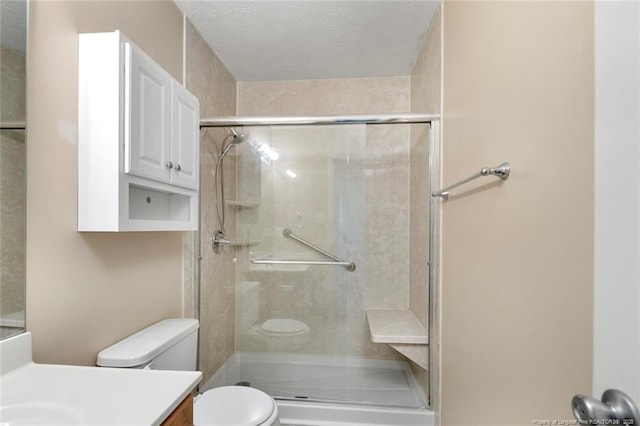 2495 Ohara Dr, Raeford, NC 28376 - full bathroom with an enclosed shower, toilet, a textured ceiling, and vanity
