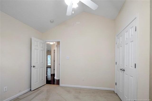 2495 Ohara Dr, Raeford, NC 28376 - unfurnished bedroom with baseboards, light carpet, a closet, and lofted ceiling