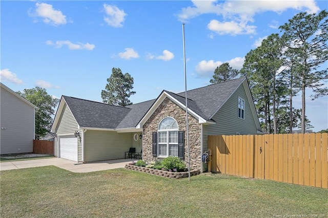 view of front of home featuring a garage, fence, stone siding, and concrete driveway