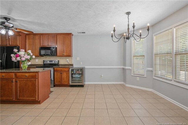 kitchen featuring black microwave, beverage cooler, electric stove, decorative backsplash, and visible vents