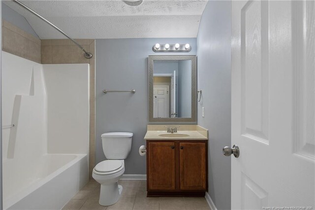 bathroom with a textured ceiling, tile patterned flooring, vanity, toilet, and shower / bathtub combination