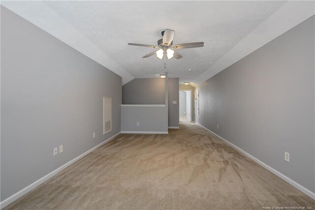 bonus room with baseboards, a ceiling fan, and carpet