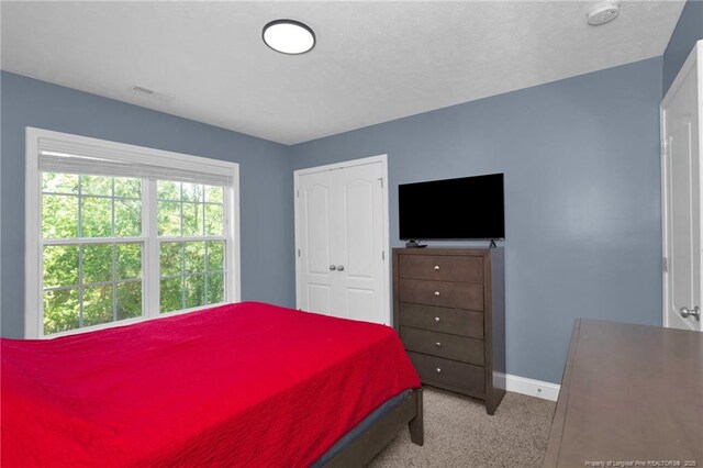 bedroom with baseboards, carpet, and visible vents