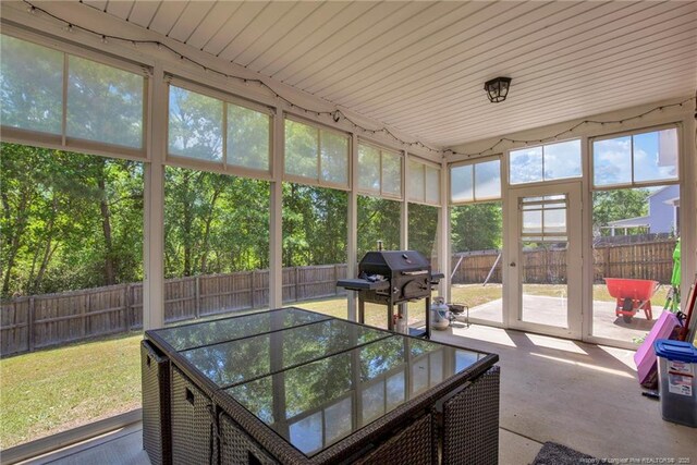 sunroom / solarium featuring a healthy amount of sunlight and outdoor dining area