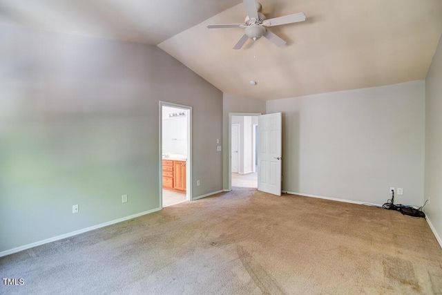 unfurnished bedroom with light carpet, ensuite bath, a ceiling fan, baseboards, and lofted ceiling