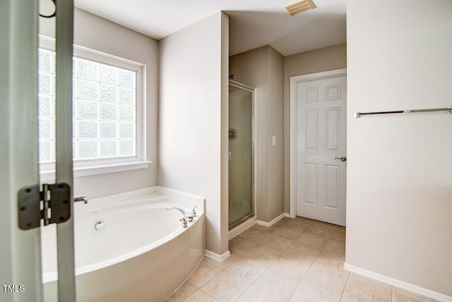 full bath with visible vents, tile patterned flooring, baseboards, a bath, and a shower stall