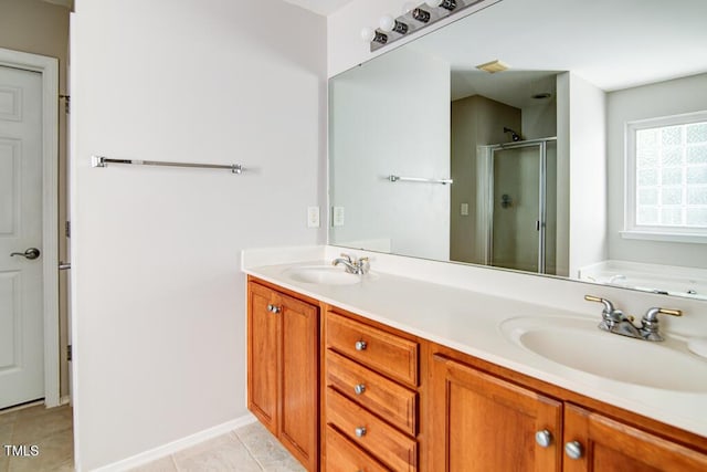 bathroom featuring double vanity, a sink, a bath, and a stall shower