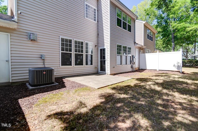 rear view of house featuring fence and a patio