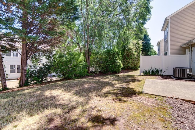 view of yard featuring fence, cooling unit, and a patio area