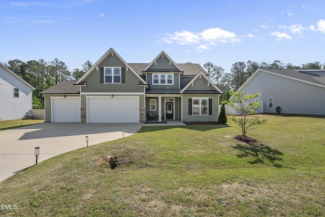 craftsman-style home featuring a front lawn, an attached garage, stone siding, concrete driveway, and a porch