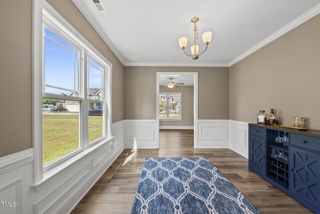 sitting room featuring visible vents, wainscoting, crown molding, and dark wood-style flooring