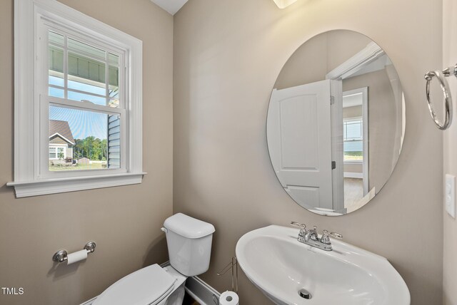 half bathroom featuring a sink and toilet