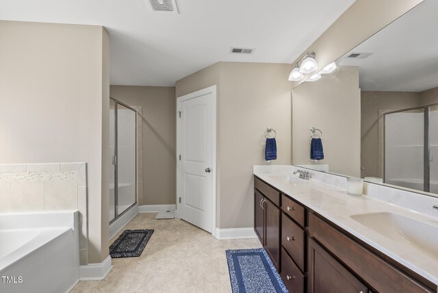 bathroom featuring a garden tub, double vanity, a sink, and a shower stall