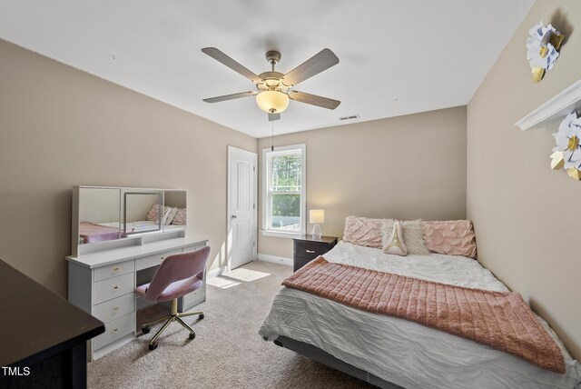 bedroom with light colored carpet, a ceiling fan, visible vents, and baseboards