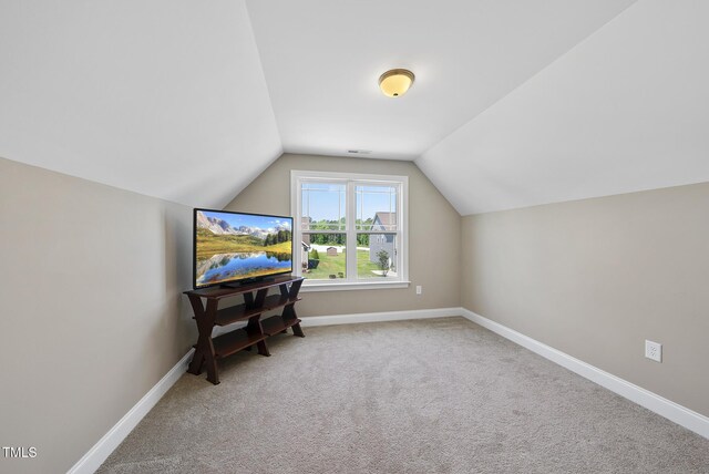 bonus room with carpet floors, baseboards, visible vents, and lofted ceiling