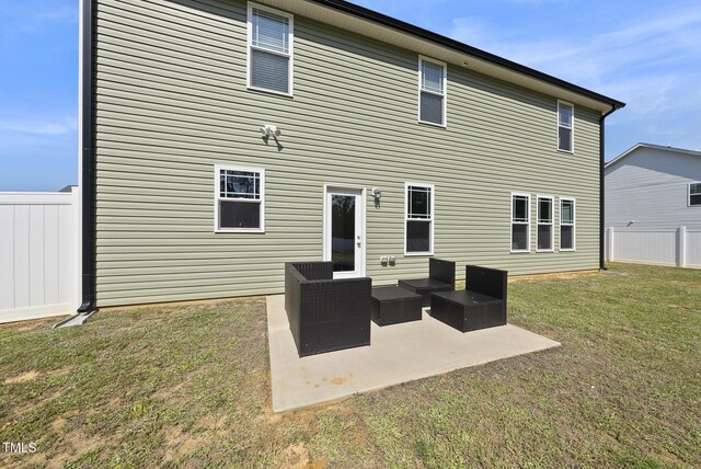 back of house featuring a lawn, fence, an outdoor hangout area, and a patio area