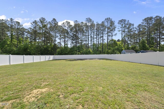 view of yard with a fenced backyard