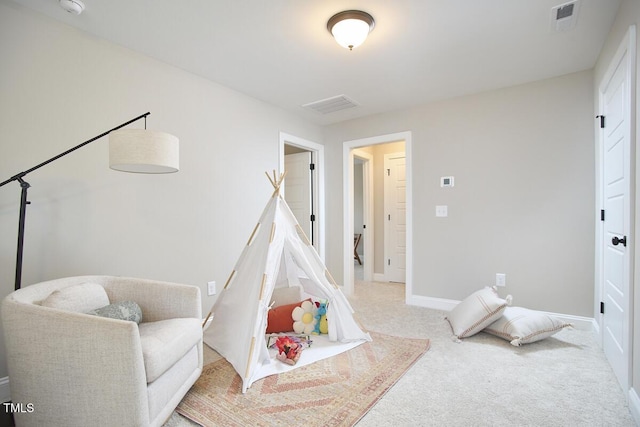 recreation room with baseboards, carpet, and visible vents