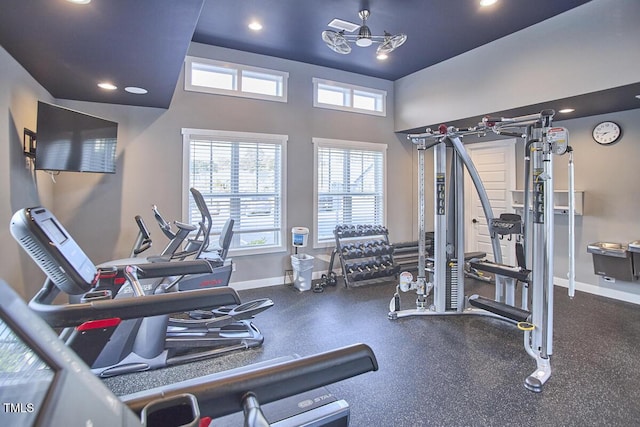 gym featuring recessed lighting, baseboards, and plenty of natural light