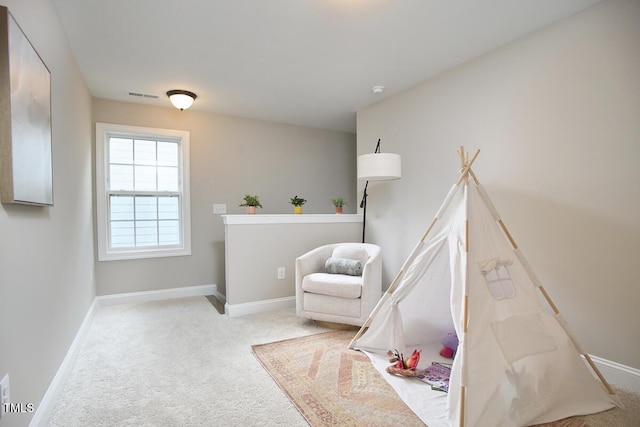 interior space with baseboards, carpet flooring, and visible vents