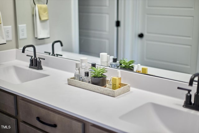 bathroom featuring a sink and double vanity