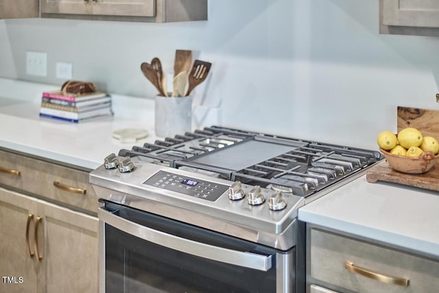 interior details with light countertops and stainless steel gas range oven