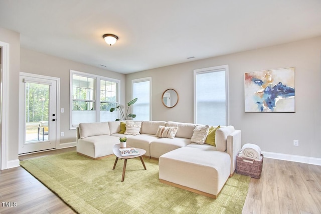 living room with baseboards and wood finished floors