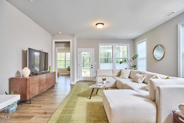 living room featuring visible vents and light wood finished floors