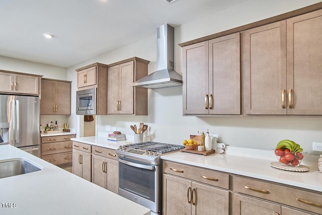 kitchen with light countertops, a sink, stainless steel appliances, recessed lighting, and wall chimney exhaust hood