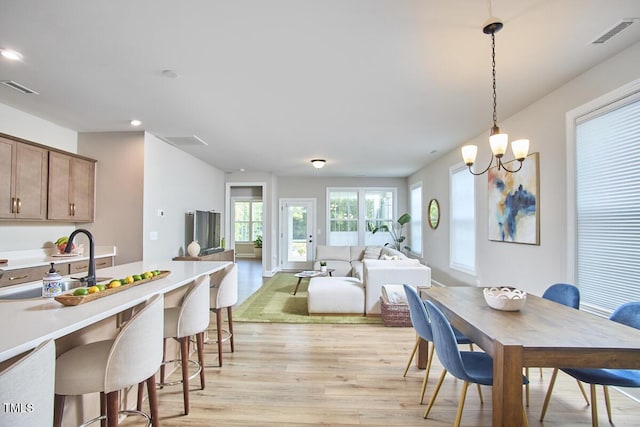 dining space with recessed lighting, visible vents, and light wood finished floors