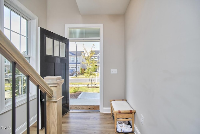 entryway featuring baseboards and wood finished floors