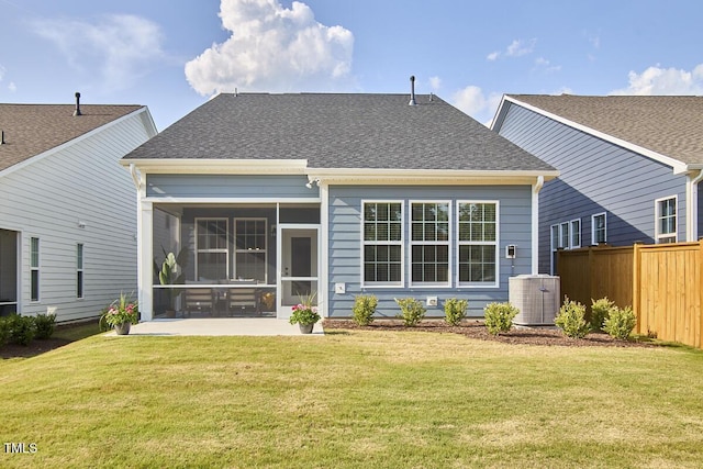 back of property featuring a yard, fence, central AC unit, and a sunroom