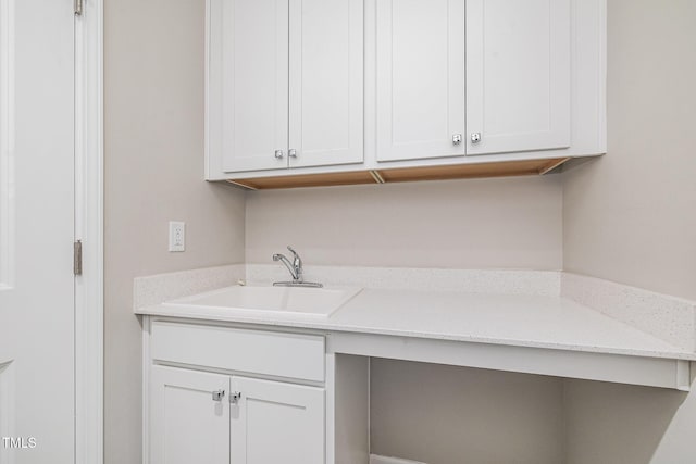 clothes washing area featuring a sink